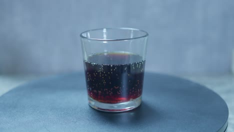 a static shot of root beer in a glass on a table