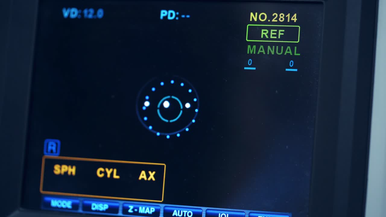Refractometer machine. Patient testing eyes in clinic. Screen showing progress of eye examination. Close-up.