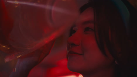 person looking at goldfish in a plastic bag