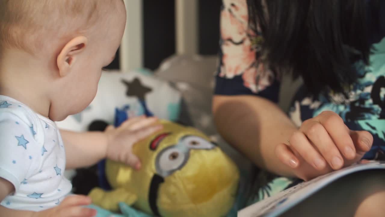 Baby with Minion Toy in Crib