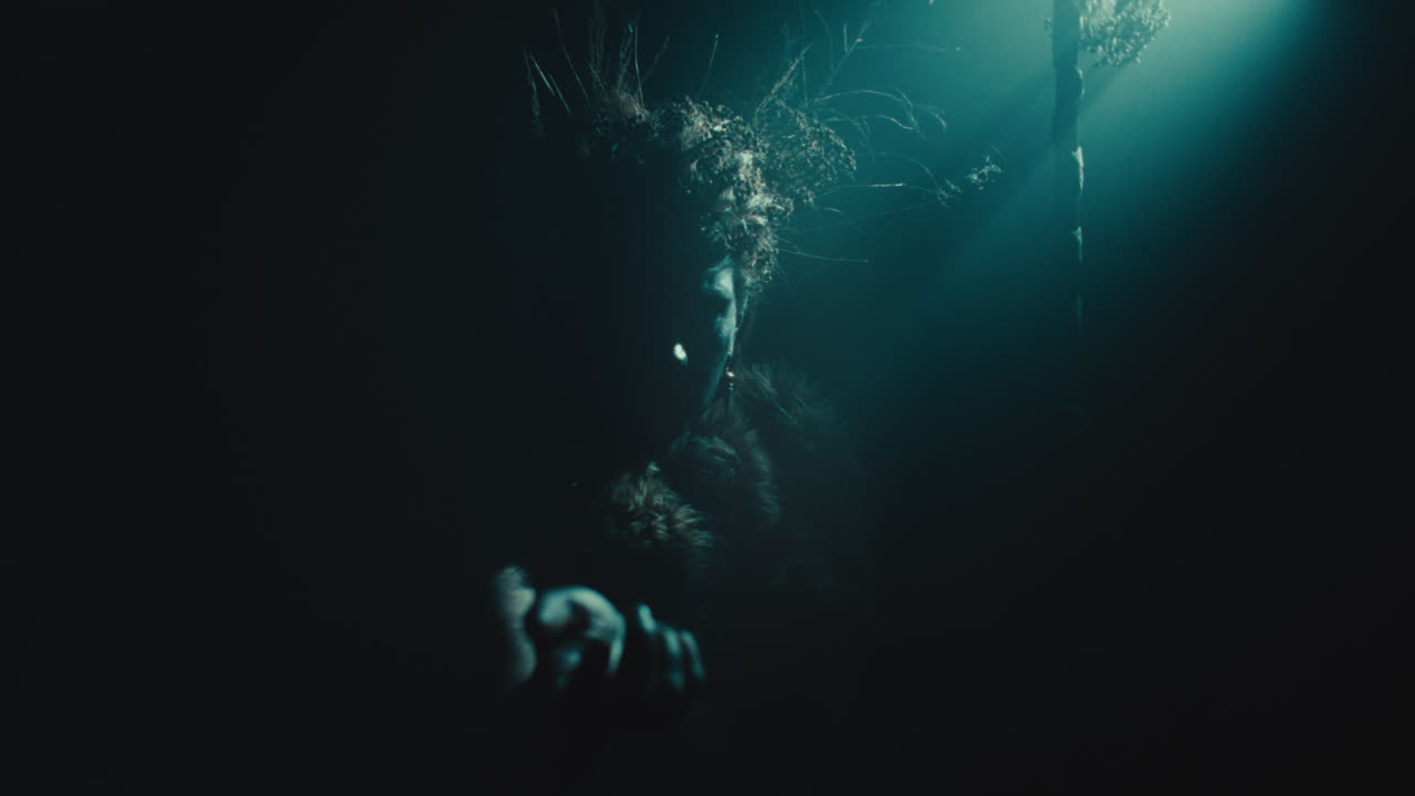 The witch makes a beckoning gesture with her hand