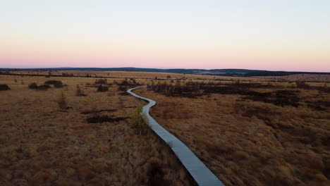 winding pathway of natural flatlands during sunset, aerial view