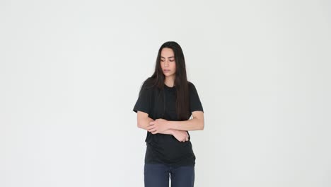 young woman expressing discomfort or cold on white background