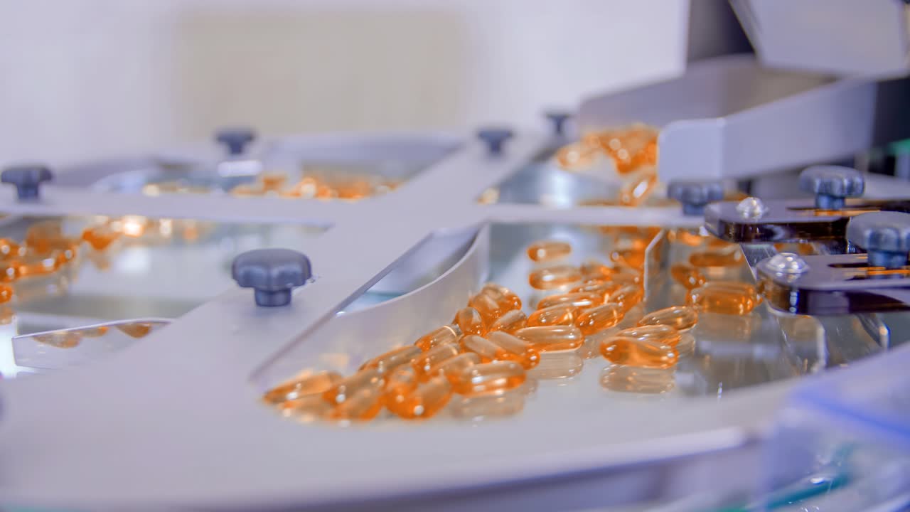 A pharmaceutical lab producing orange gel capsules for COVID-19 treatment
