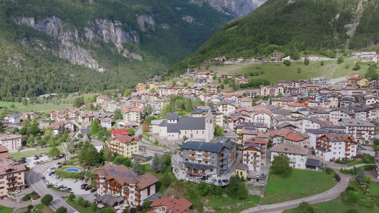 Aerial video panning down from the town of Molveno in northern Italy with the Dolomite mountains in the background.