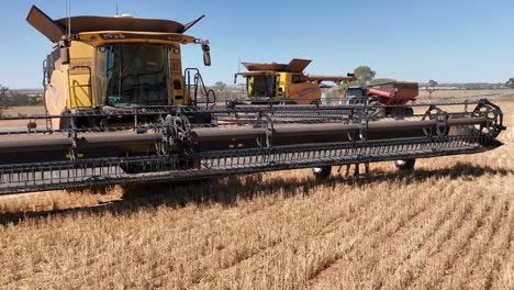 This-footage-captures-the-synergy-of-modern-agricultural-technology,-showcasing-the-essential-role-of-header-fronts-in-the-wheat-harvesting-process