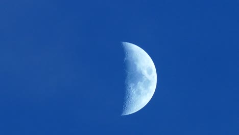 light blue sky, the crescent moon and moving clouds,