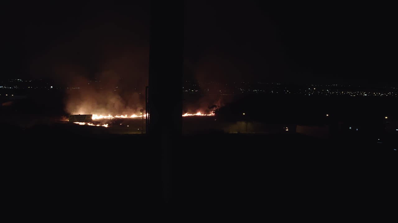 View of wild fire from the city. Night view of the wild fire across the road