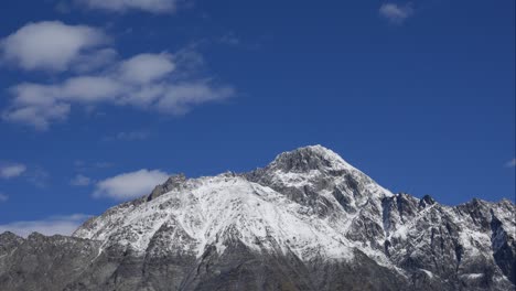 blue sky white clouds over snow mountains. puffy fluffy white clouds. cumulus cloud scape timelapse. winter blue sky time lapse. dramatic majestic amazing blue sky. soft white clouds form. clouds time lapse background