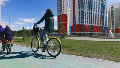 family cycling in a modern city park