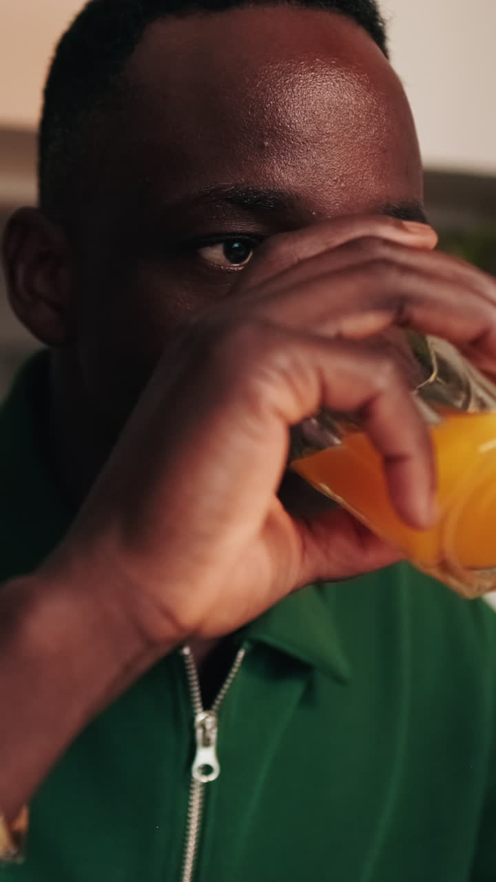 Close-up of Young Black Man Drinking Orange Juice