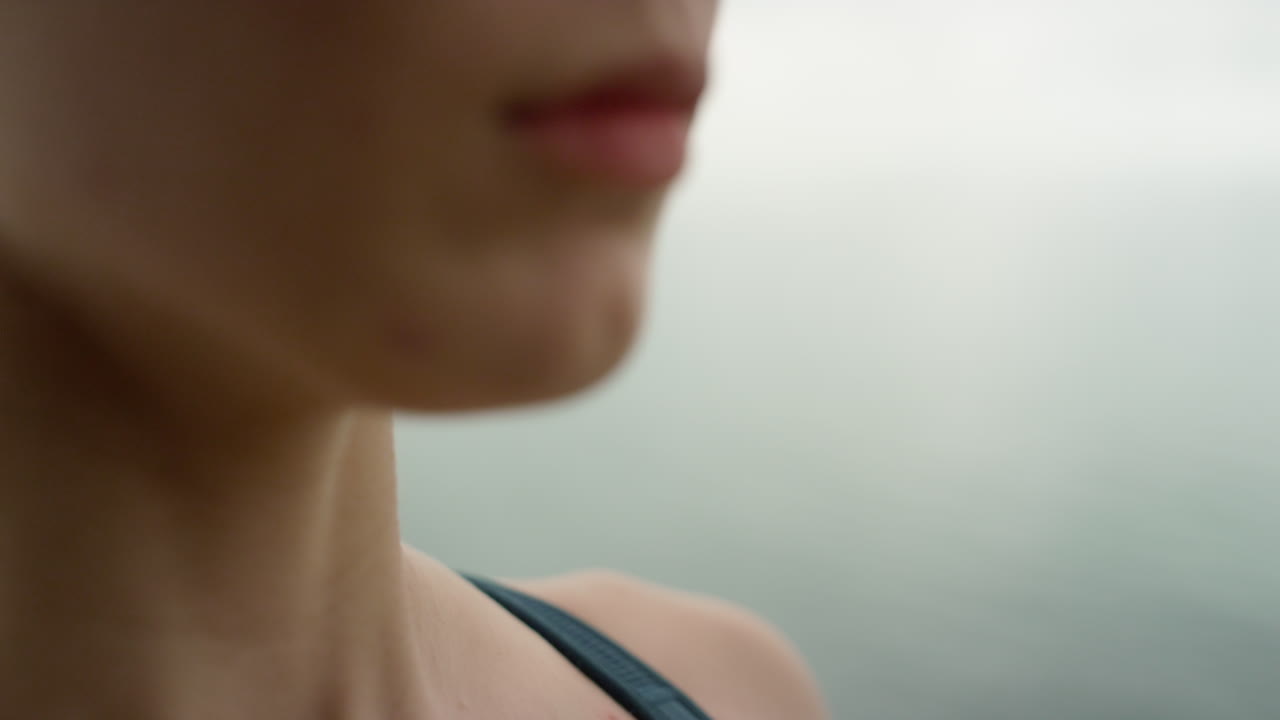 Girl doing breathing exercise on beach closeup. Woman practicing yoga meditation