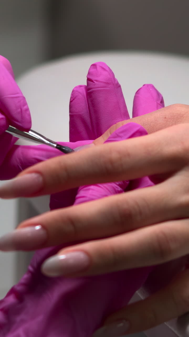 Manicurist Applying Gel to Client's Fingernails
