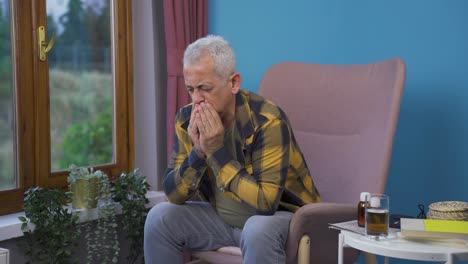 man covering his mouth and nose while coughing.