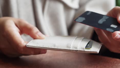 woman holding a wallet with credit cards