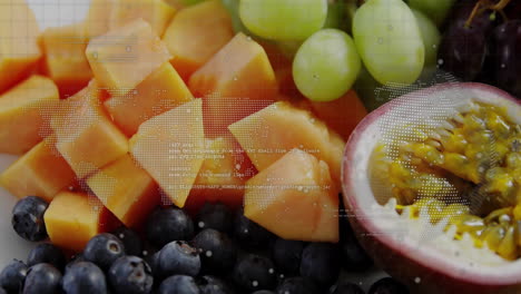 digital data processing animation overlaying assorted fruits on table display