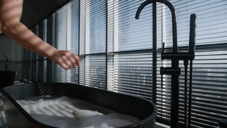 Woman Relaxing in a Modern Bathtub with City View