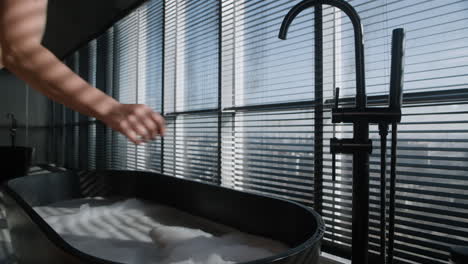 Woman Relaxing in a Modern Bathtub with City View