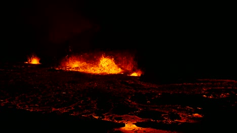 idyllic footage of hot lava and magma splashing dramatically in an active volcanic crater, showcasing raw power of nature and vivid colors of molten rock at night in iceland