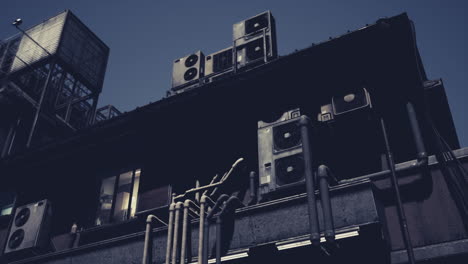 urban rooftop with multiple air conditioning units at dusk in a city