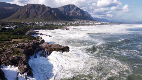 seascape aerial view as wave crashes impressively with big splash into rocks