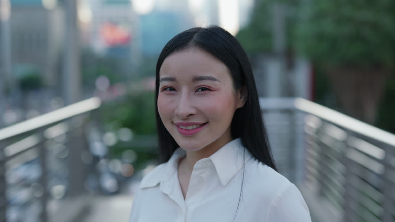 Close-up Portrait of a Smiling Asian Woman in an Urban Setting
