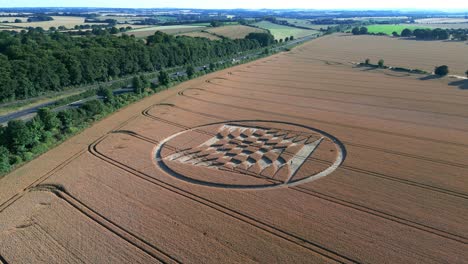 crop circles with tractor tracks on agricultural field at summer