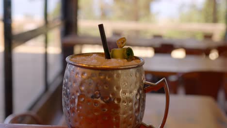 close-up-video-of-a-drink-served-in-a-cold-metal-glass-with-cucumbers-and-lemon