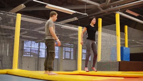 people practicing acrobatics on a trampoline