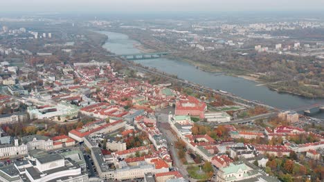 aerial pullback, revealing warsaw cityscape with visttula river, poland