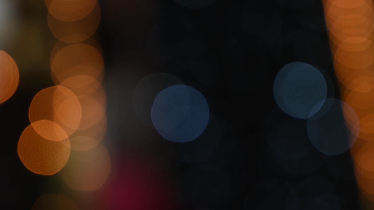 Blurred view of blue Christmas lights on a black background