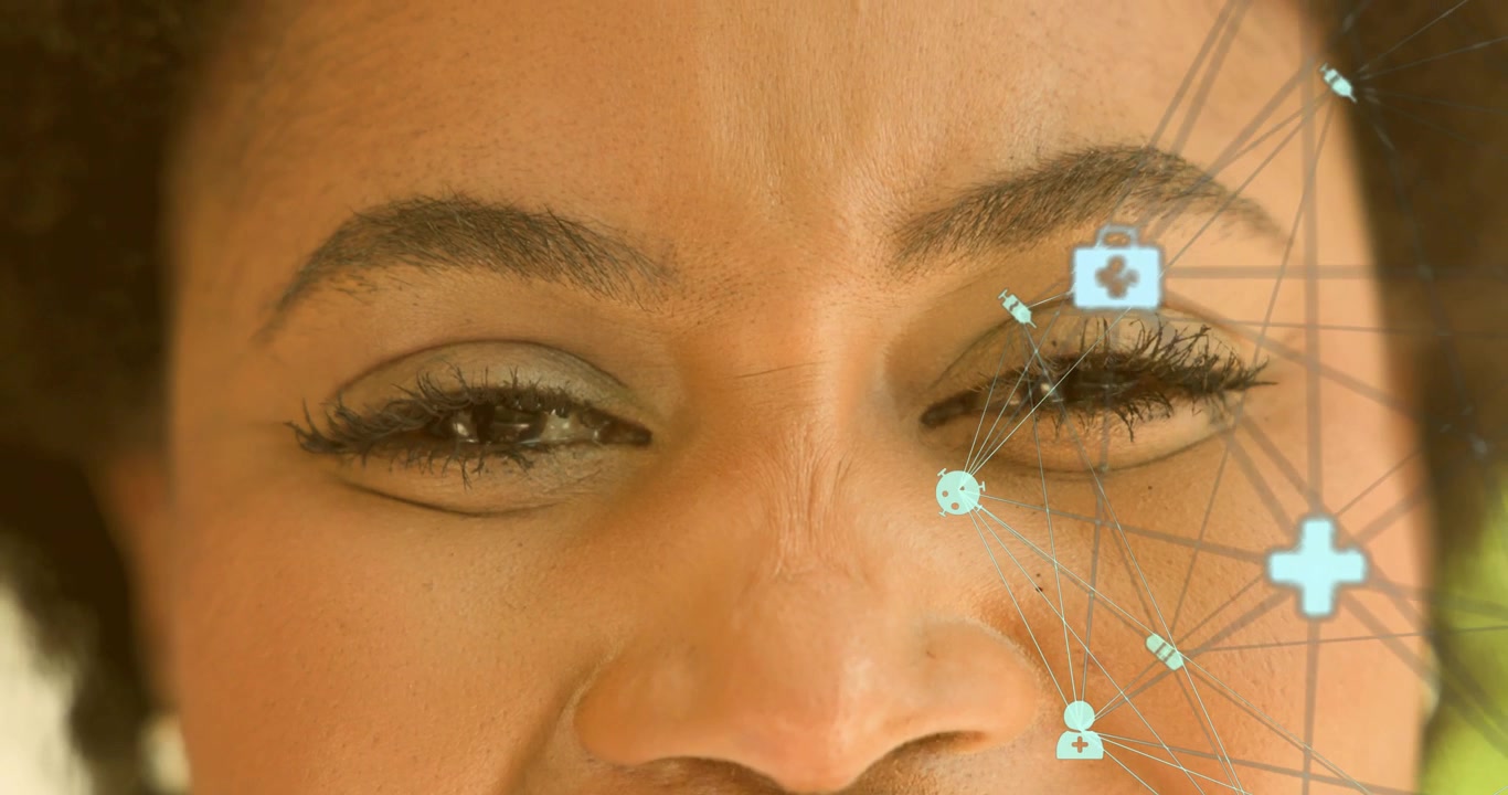 Middle-aged woman looking forward as digital overlaying health icons, blinking eyes scanning nodes