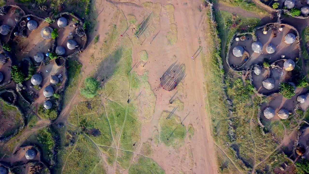 Top Down View Of Karamojong Dancing In Between Two Villages In Uganda - Drone Shot