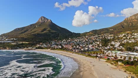 imagine a drone gliding smoothly over the pristine shores of camps bay beach.