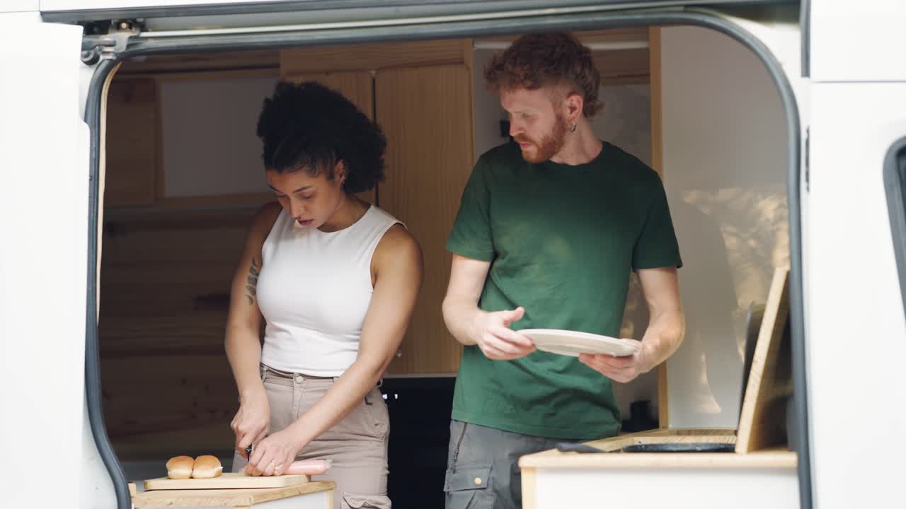 Couple cooking food in a van