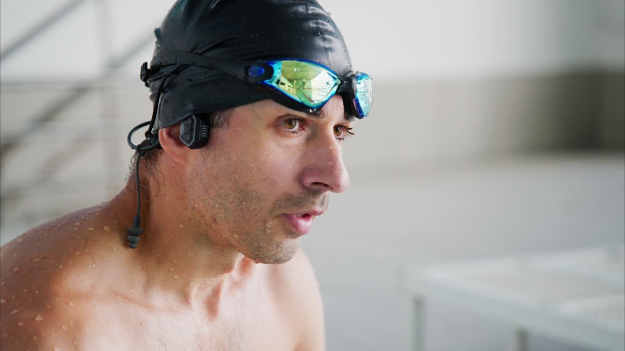 Determined Swimmer Preparing for Performance: Focused Athlete Adjusting Swim Cap and Goggles Before Training Session in a Pool Environment
