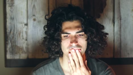 tired caucasian man with computer working late at night home office