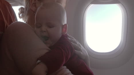 mother and baby daughter traveling by air