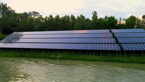 Captivating-aerial-4K-drone-footage-of-a-solar-panel-plant-nestled-alongside-the-Drava-river-in-Slovenia