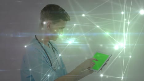 Animation-of-network-of-connections-over-caucasian-male-surgeon-using-tablet