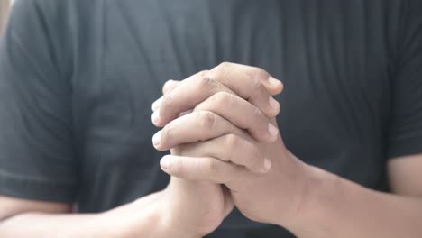 close up of hands praying christian