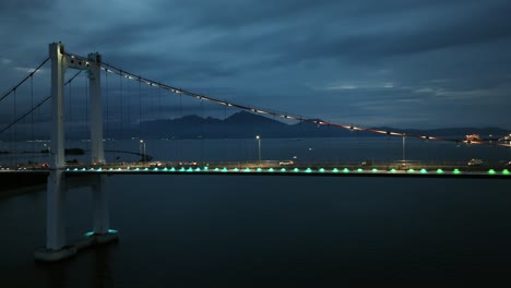 tracking cars driving on suspension bridge at night