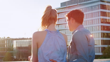 romantic couple standing on bridge over river thames in london