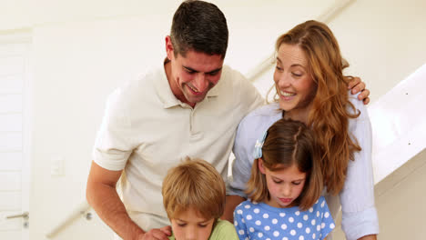 Happy-parents-and-children-drawing-together-looking-at-camera