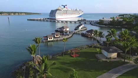 aerial flyover cruise ship parking at amber cove with apartments on wooden footbridge