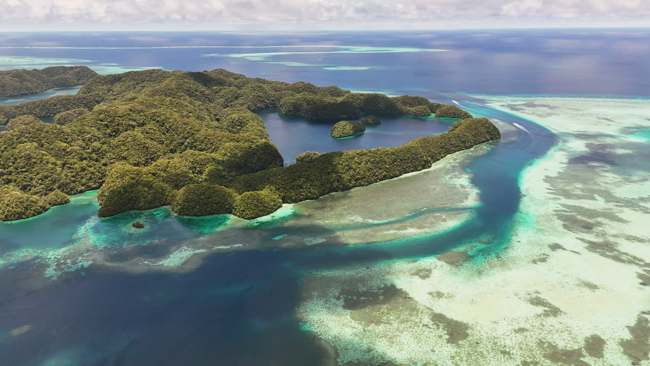 Sweeping drone shot scanning and revealing the pristine turquoise sea and lush islets in Palau. wide revealing aerial shot