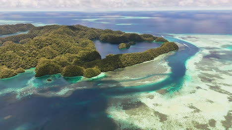 sweeping drone shot scanning and revealing the pristine turquoise sea and lush islets in palau. wide revealing aerial shot