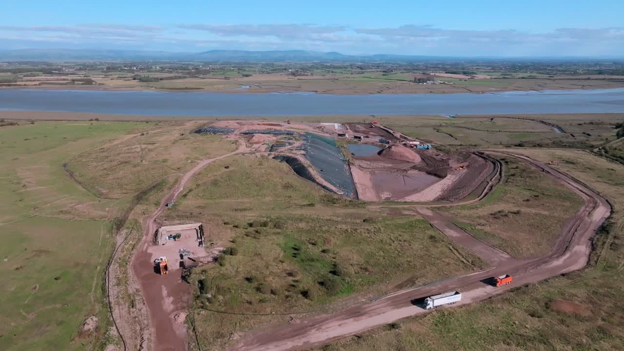 Landfill Site Next To River Wyre With Trucks Moving. Jameson Road Landfill And Recycling Site, Fleetwood, UK