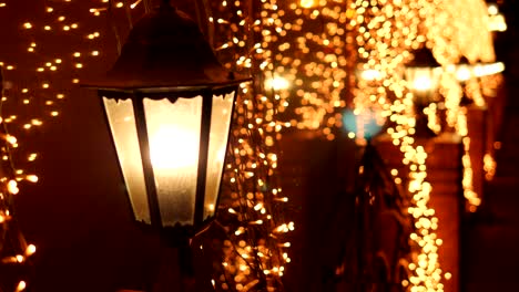 luces doradas borrosas festivas de las lámparas de la calle en la noche de navidad en la calle