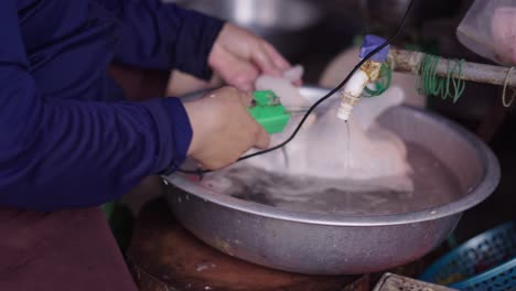 preparing chicken at a market